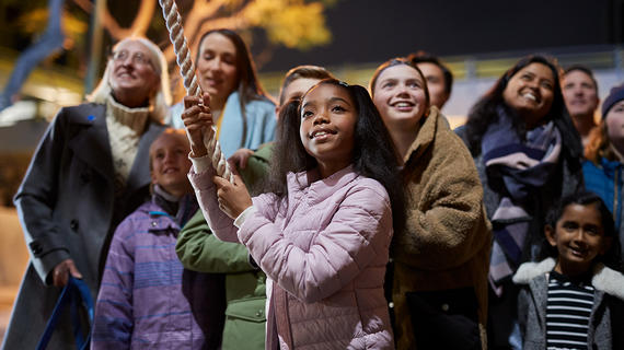 Young girl surrounded by community