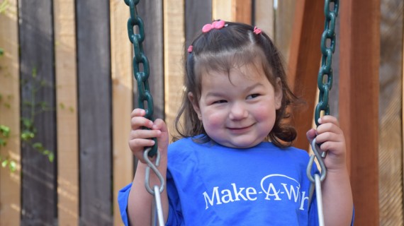 Alicia smiles on swing