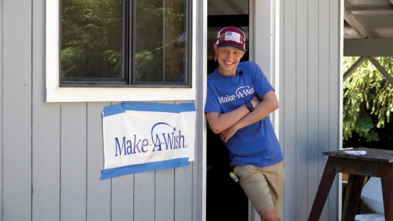 Keegan stands outside of his woodshop